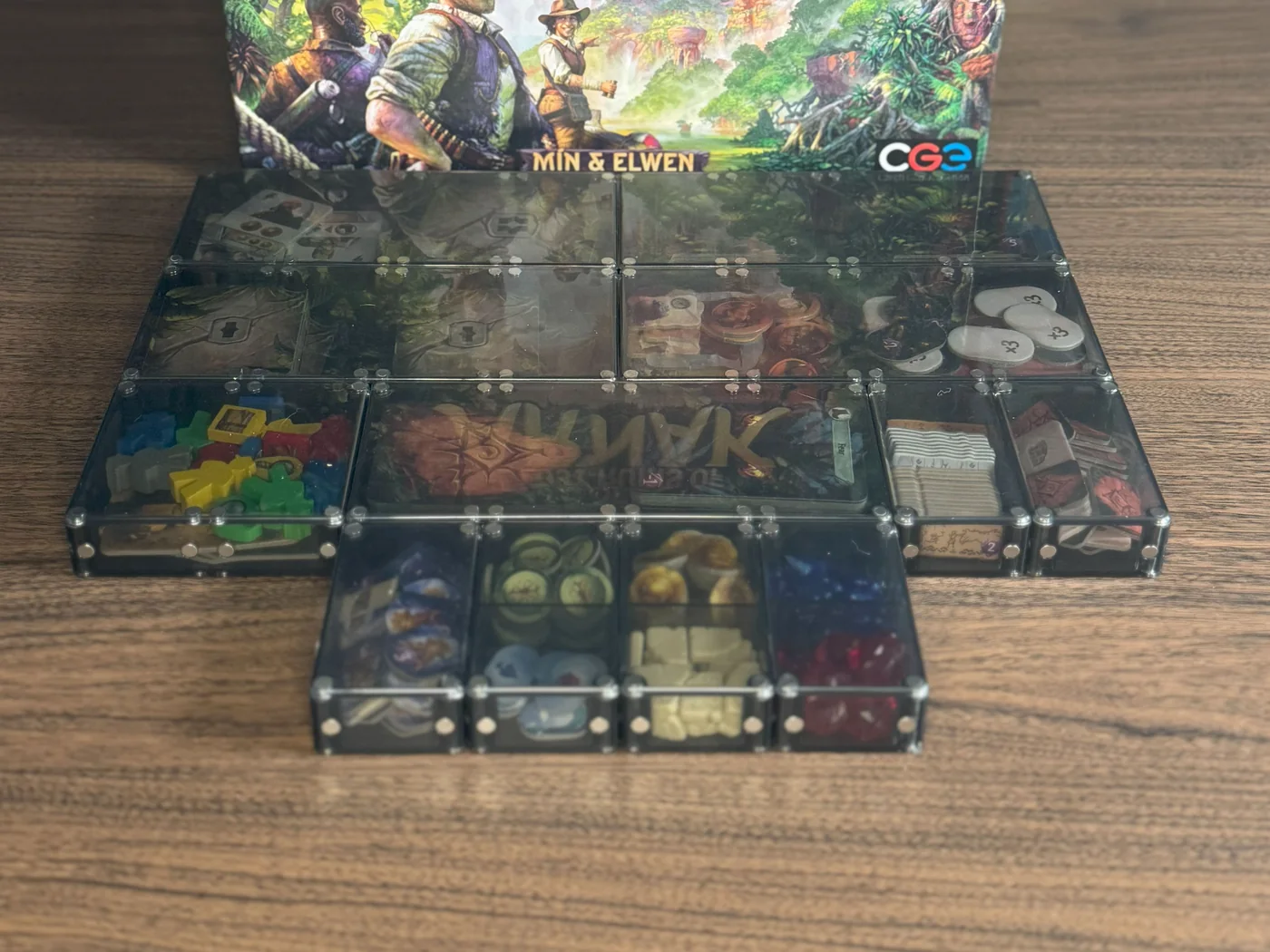 Lost Ruins of Arnak components in Piece Keepers trays, with Unity Vault Lids spanning each group