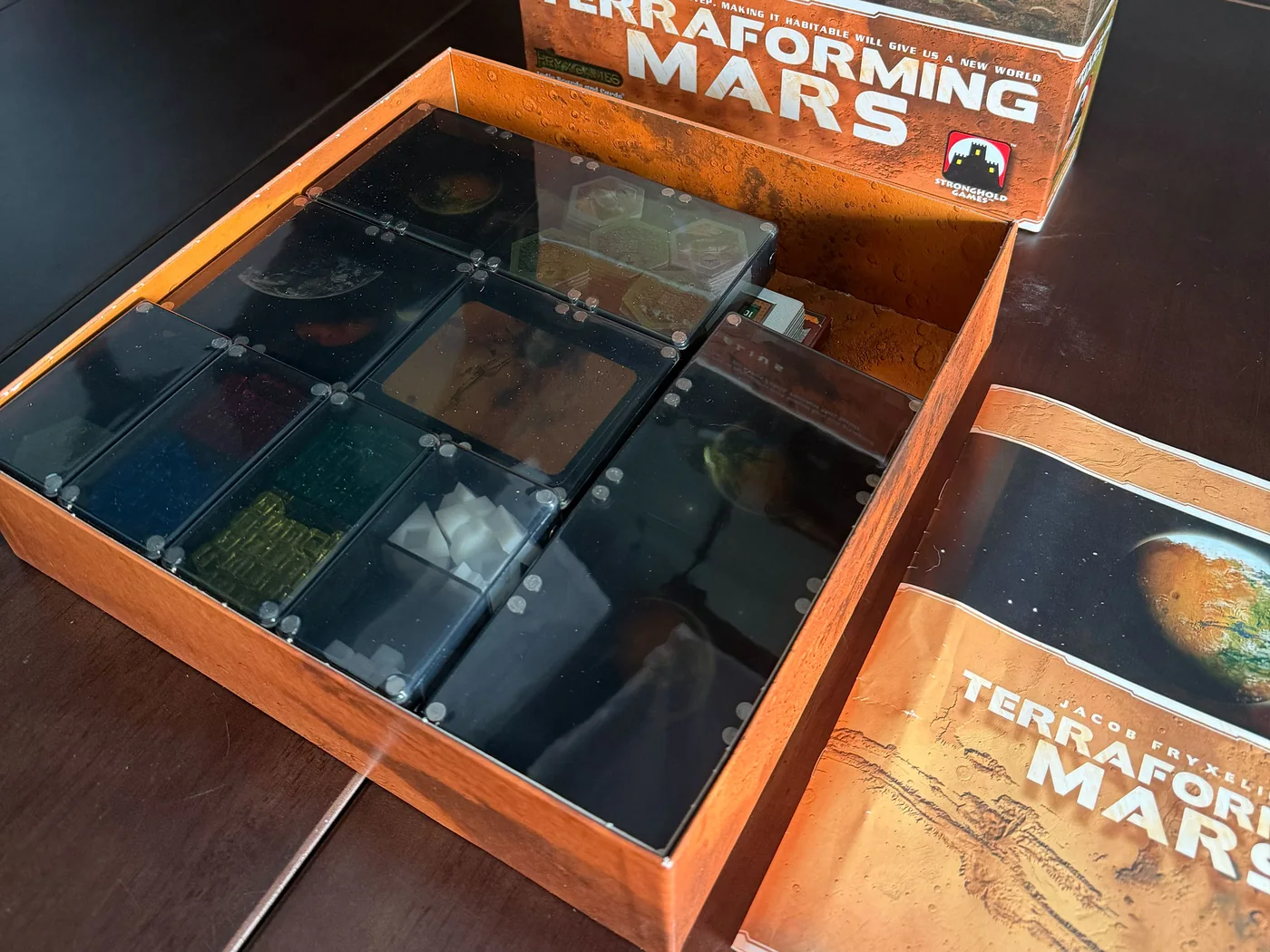 Terraforming Mars components sorted into Piece Keepers trays in the box