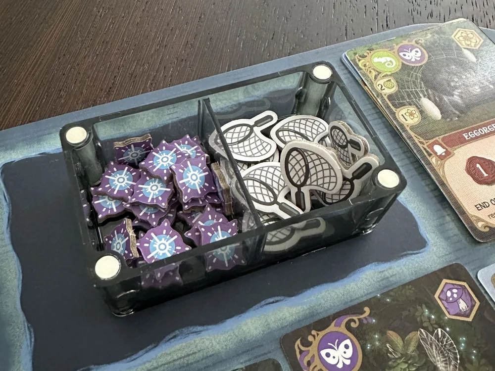 A Double Piece Keeper holding energy tokens and nets, sitting on the Wondrous Creatures board mid-game