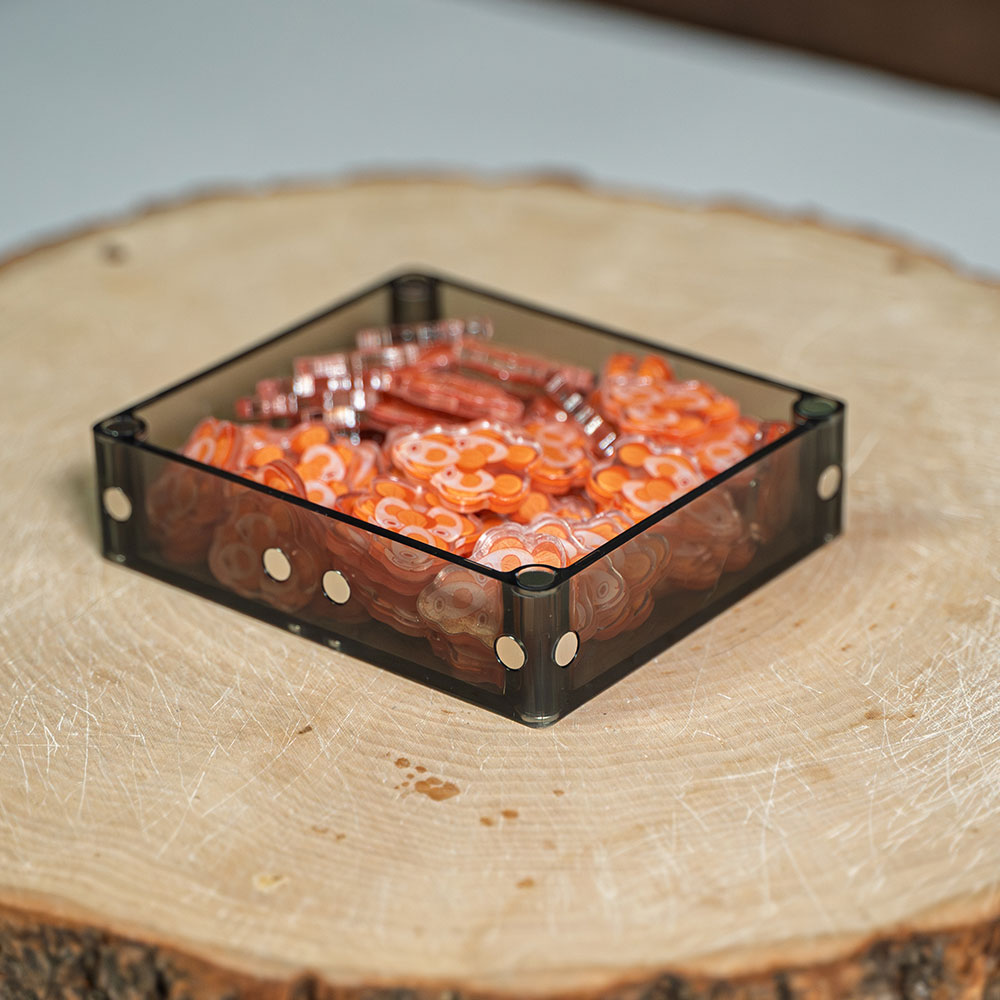 A Double resting on a wood slice, filled with orange fish tokens